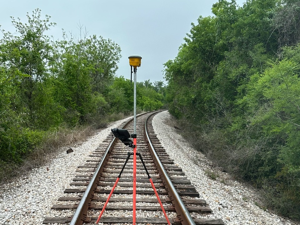RTK GPS rover set up along a rail corridor, tied to project control